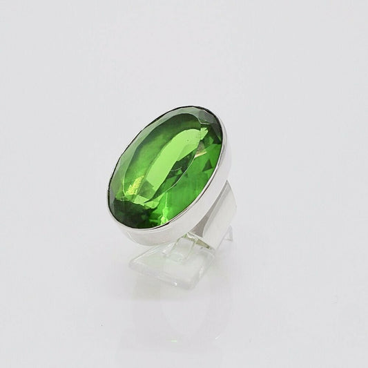 Silver ring featuring a large oval emerald-green obsidian stone (2x3 cm) set in a sleek bezel.