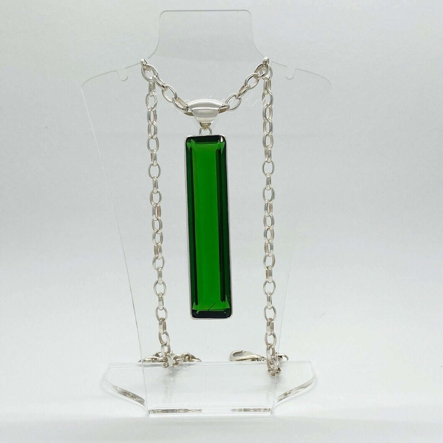 Silver pendant with emerald-green obsidian rectangle (1.5 × 7 cm) on a silver chain.