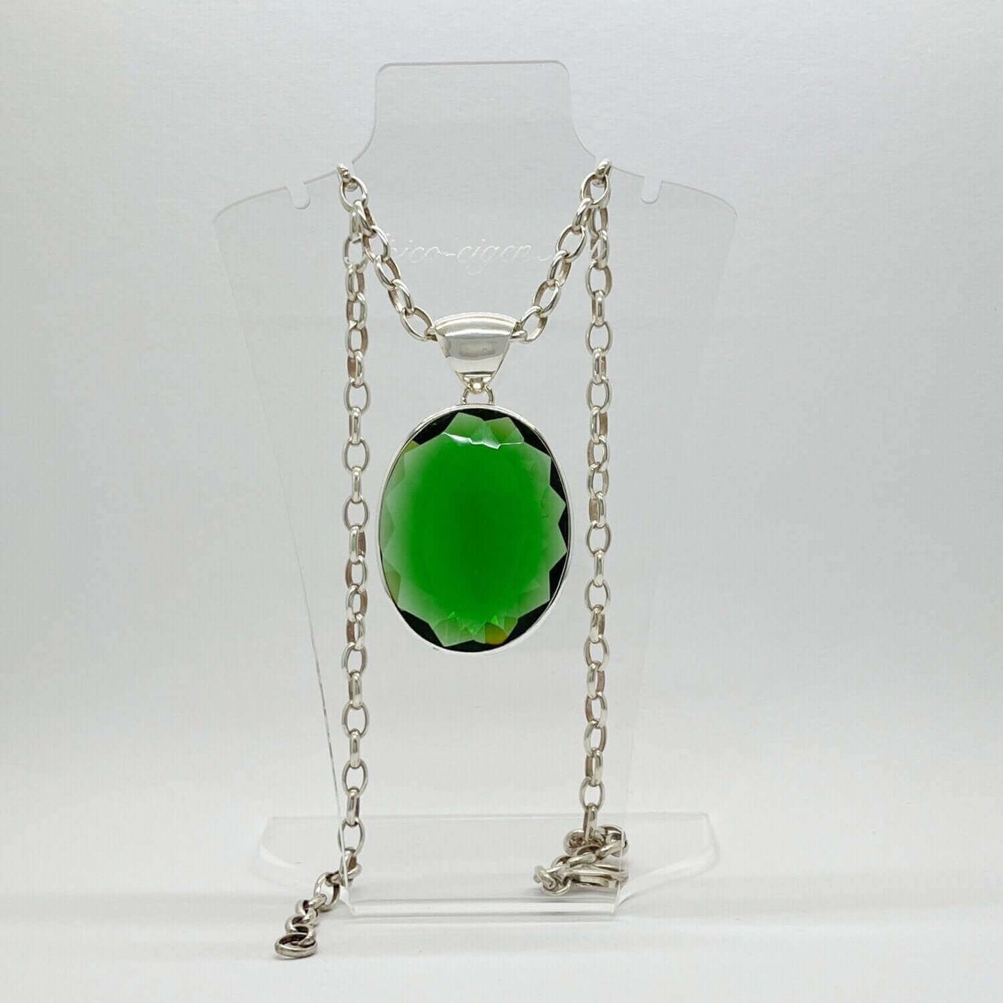 Emerald-green obsidian oval pendant in silver setting on a chain, 3 x 4 cm.