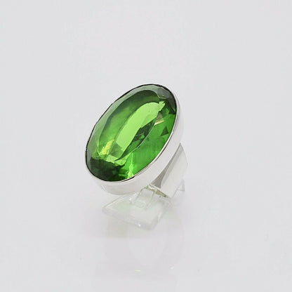 Silver ring featuring a large oval emerald-green obsidian stone (2x3 cm) set in a sleek bezel.