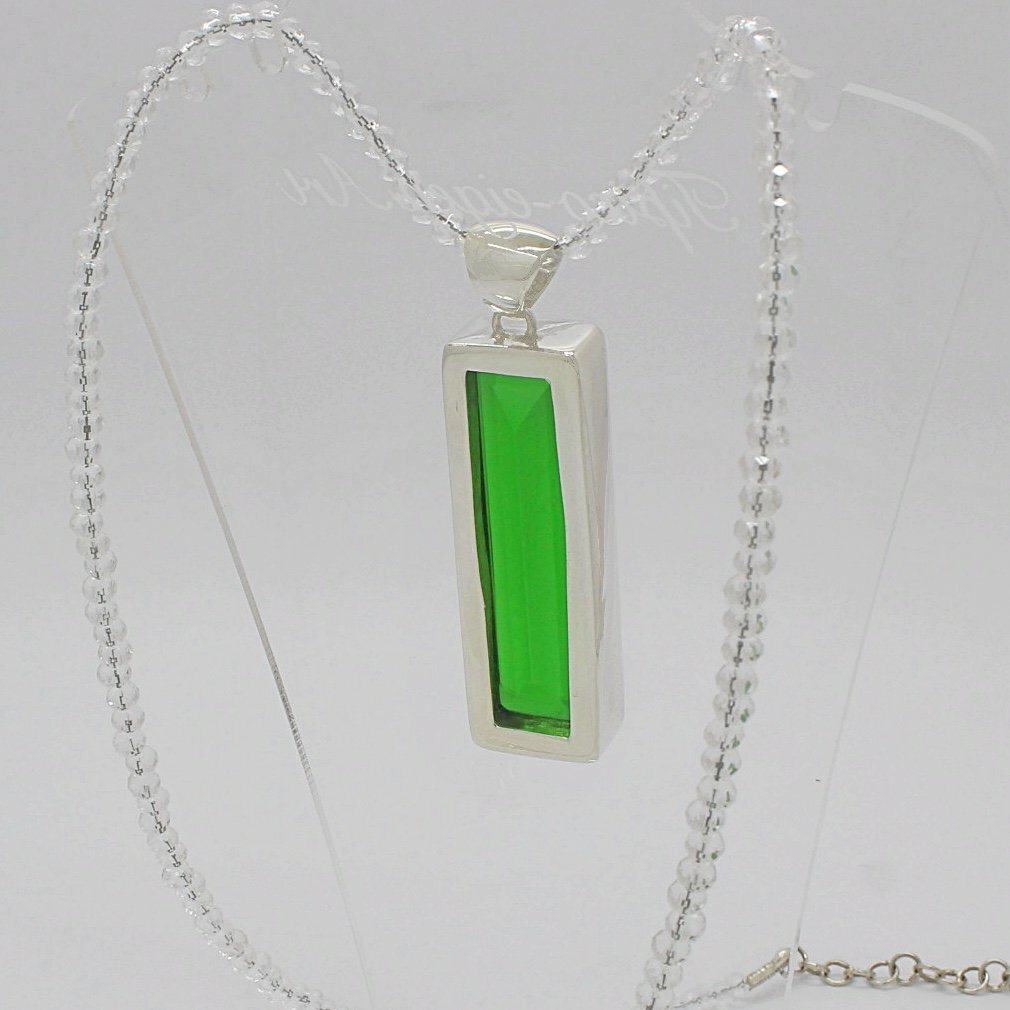 Silver pendant with emerald-green obsidian rectangle, 1.5 x 5 cm, on a delicate silver chain.
