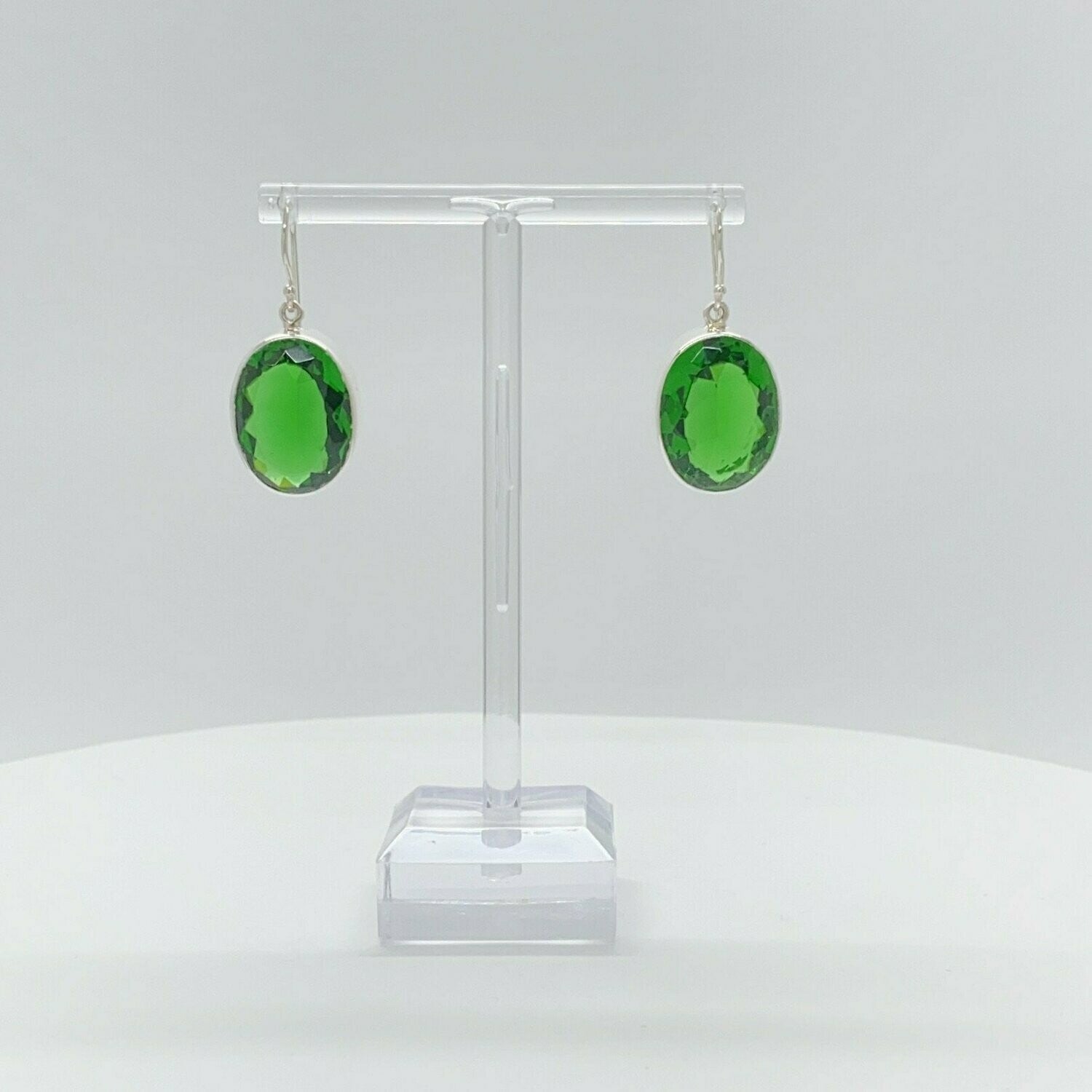 Oval emerald-green obsidian earrings, 1.5 x 2 cm, set in 925 sterling silver, handmade in Germany.
