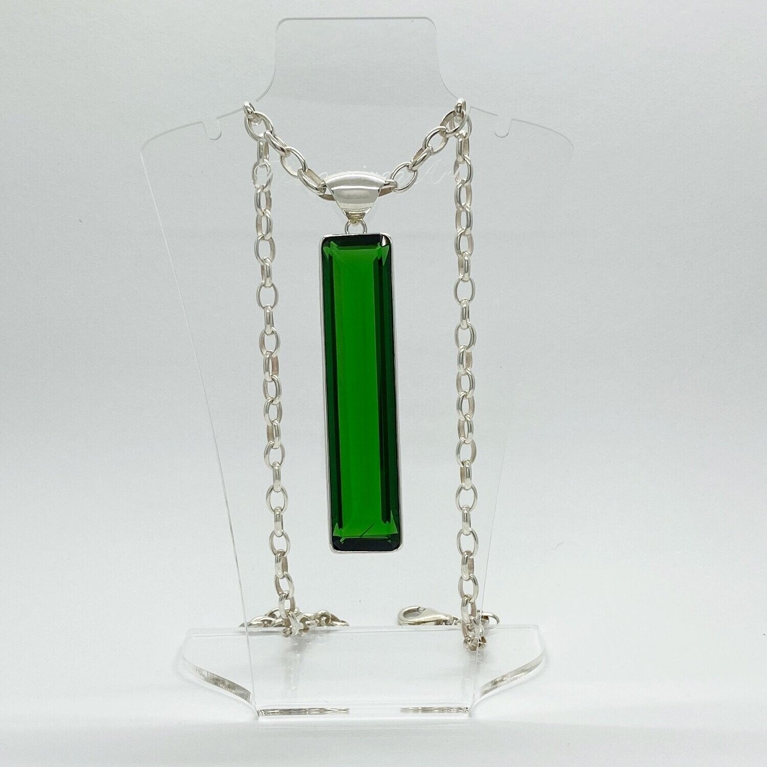 Silver pendant with emerald-green obsidian rectangle (1.5 × 7 cm) on a silver chain.