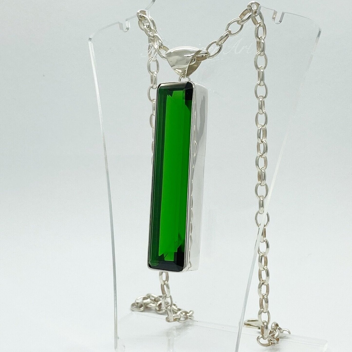 Silver pendant featuring emerald-green obsidian rectangle (1.5 × 7 cm) on a silver chain.