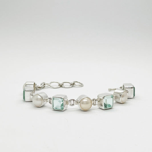 Meeresblaues Armband aus 925er Silber mit Perlen und quadratischen aquamarinfarbenen Steinen.