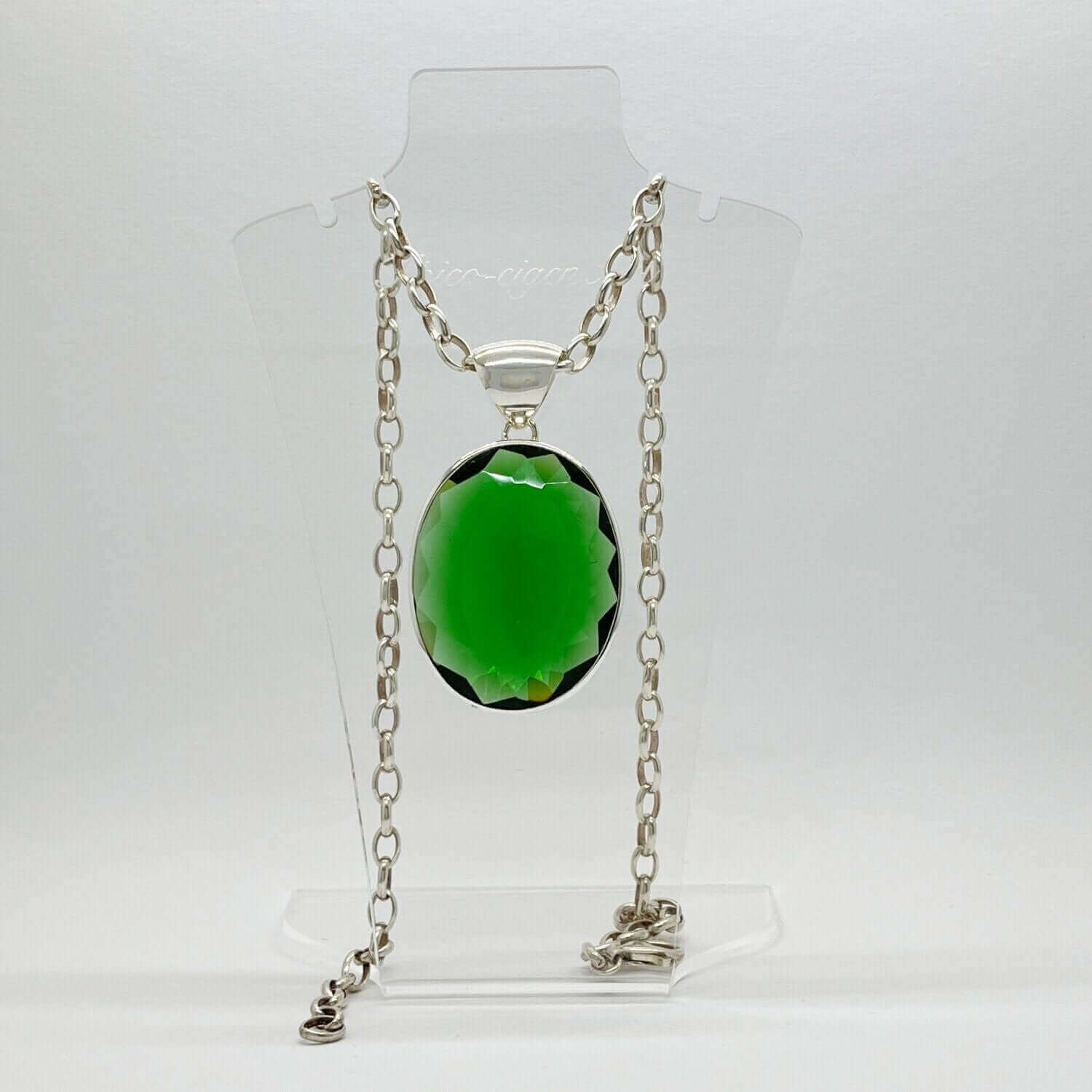 Emerald-green obsidian oval pendant in silver setting on a chain, 3 x 4 cm.